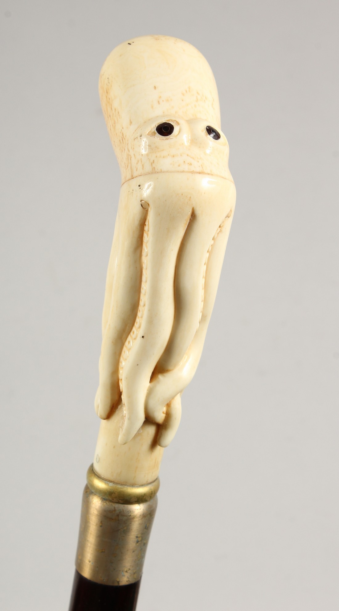 A WALKING STICK, the bone handle carved as an octopus 35.5ins long