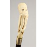 A WALKING STICK, the bone handle carved as an octopus 35.5ins long