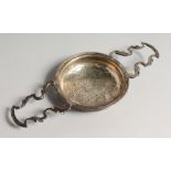 A GEORGE III TWO HANDLED LEMON STRAINER. London 1760, maker Edward Aldridge & Co.