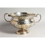 POLO INTEREST: A GOOD LARGE SILVER TWIN HANDLED PEDESTAL BOWL, with leaf cast handles and embossed