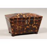 A REGENCY STYLE FAUX TORTOISESHELL TWO DIVISION TEA CADDY on wooden bun feet. 10.5ins long