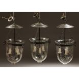 A SET OF THREE ETCHED GLASS AND METAL THREE LIGHT HANGING LANTERNS 20ins high.