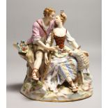 A SUPERB 19TH CENTURY MEISSEN FIGURE OF LOVERS seated on a rock, a lamb by her side, on oval rocky