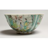 A CHINESE FAMILLE VERTE PORCELAIN BOWL, painted with figures in a landscape. 6.25ins diameter.