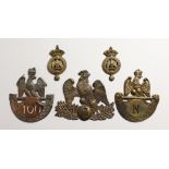 THREE LARGE NAPOLEONIC BRASS BADGES and two small badges. (5)
