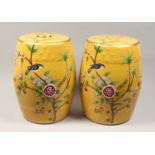 A PAIR OF CHINESE PORCELAIN BARREL SEATS, yellow ground, painted with birds. 17ins high.