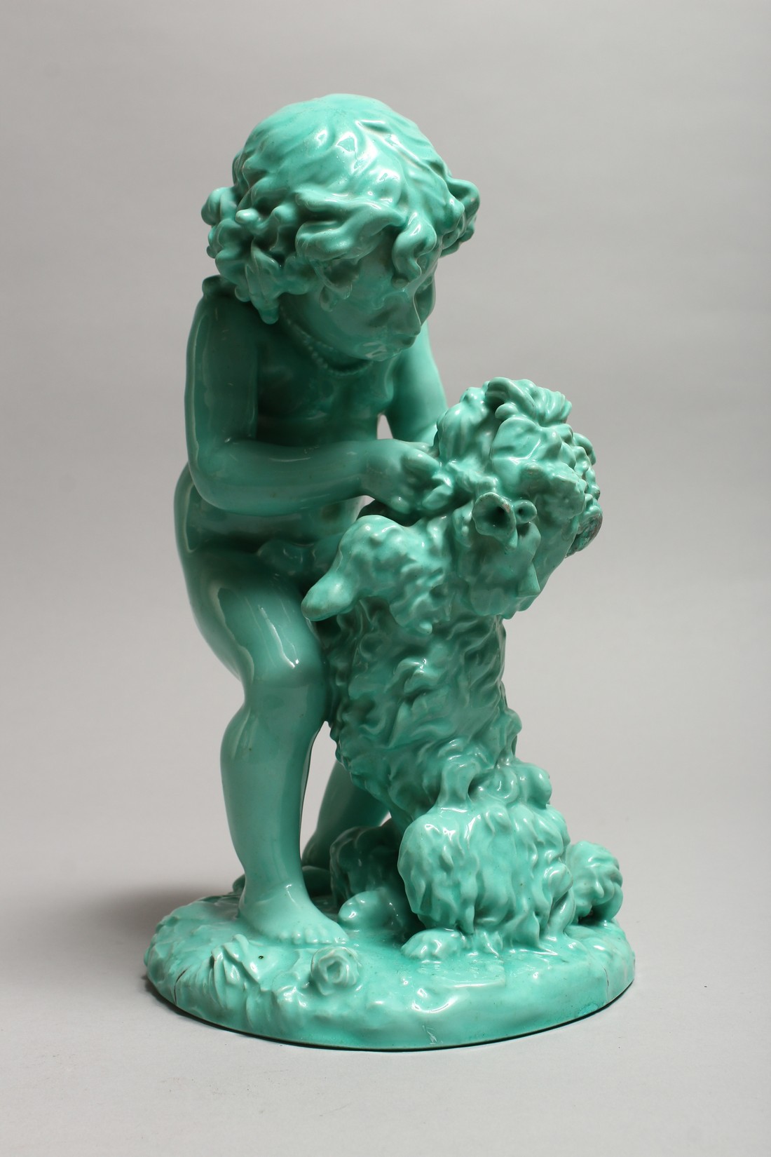 A CONTINENTAL TURQUOISE GLAZED POTTERY FIGURE of a young girl playing with a dog. 11ins high. - Image 2 of 9