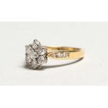 A GOOD 18K WHITE GOLD SEVEN STONE DIAMOND RING.