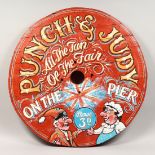 A PAINTED WOOD CIRCULAR FUN FAIR SIGN "PUNCH AND JUDY". 33ins diameter.