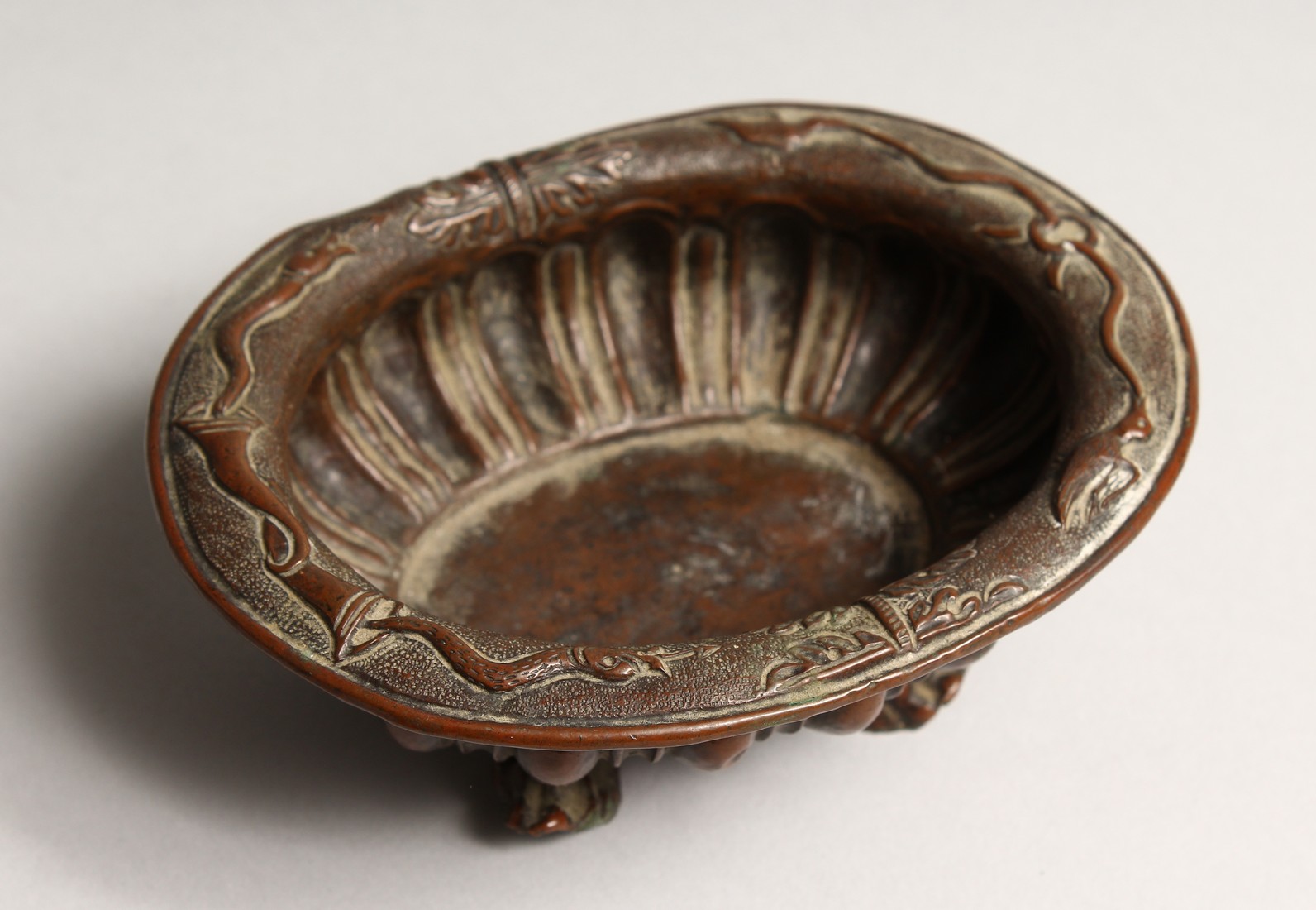 A N 18TH CENTURY DUTCH COPPER OVAL BOWL on four claw feet 5.25ins