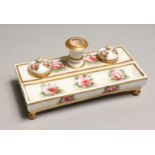 A SPODE PORCELAIN DESK STAND, with candlestick, inkwell and pounce pot, painted with pink roses