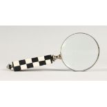 A MAGNIFYING GLASS WITH CHEQUERED HANDLE.