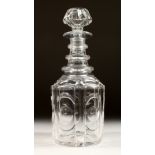 A HEXAGONAL CUT GLASS DECANTER AND STOPPER.