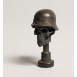 A FIRST WORLD WAR BRASS REPLICA SKULL PIPE TAMPLER 1.75ins long.