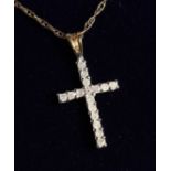 A 9CT GOLD DIAMOND CRUCIFIX ON A CHAIN.