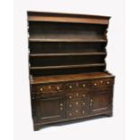 A GOOD 18TH CENTURY NORTH COUNTY OAK WELSH DRESSER the top with three shelves and hooks, the base