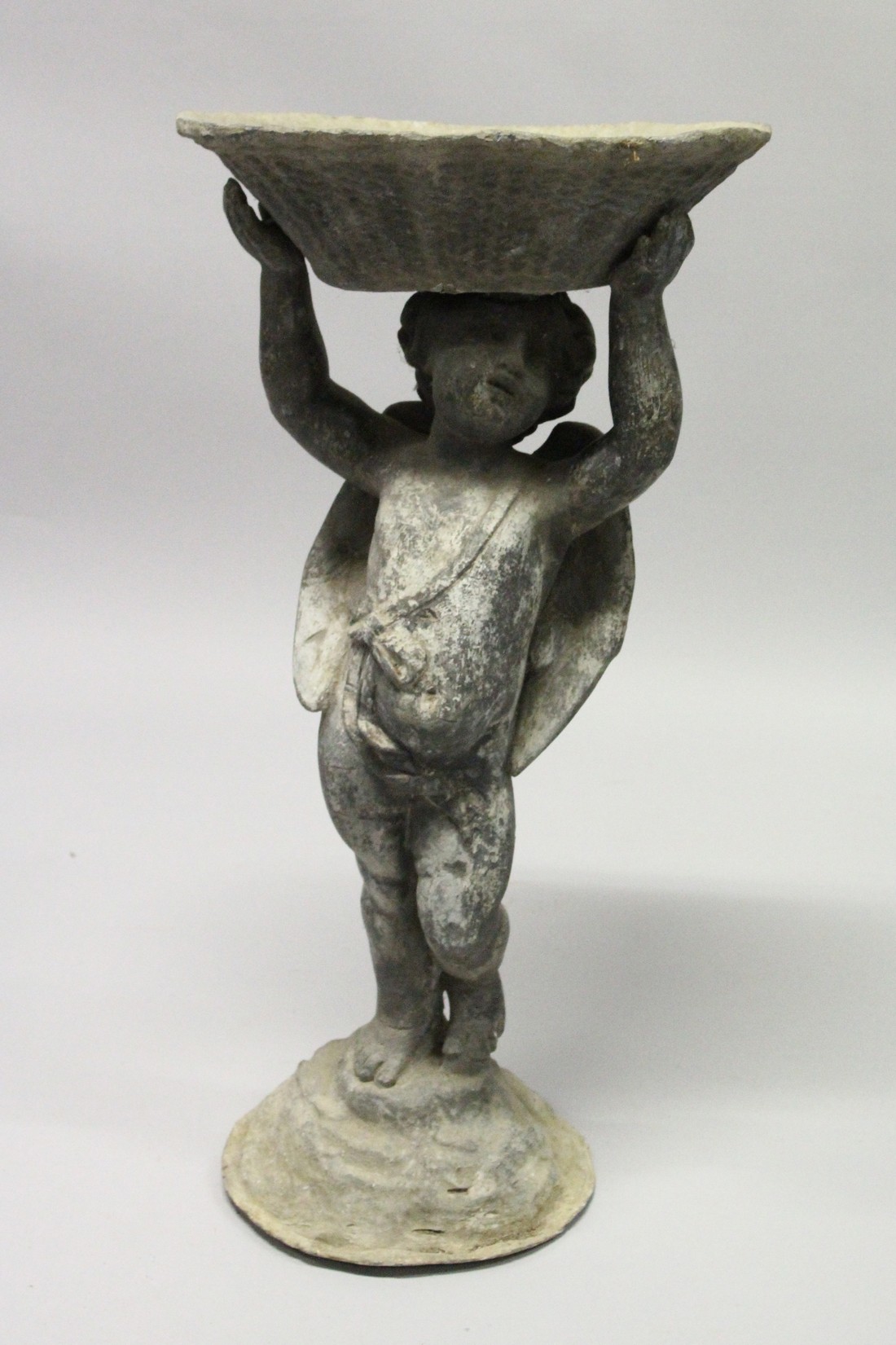 AN 18TH CENTURY LEAD BIRD BATH as a cupid holding a bowl.