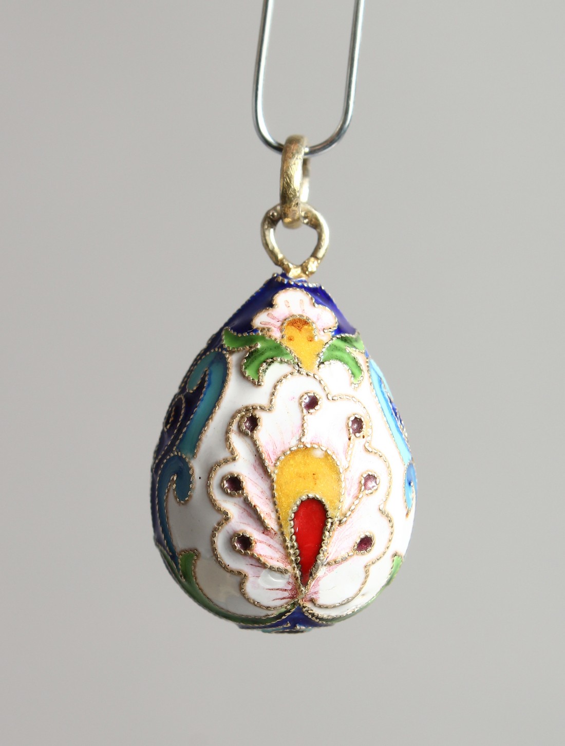 A SMALL RUSSIAN SILVER AND ENAMEL EGG PENDANT