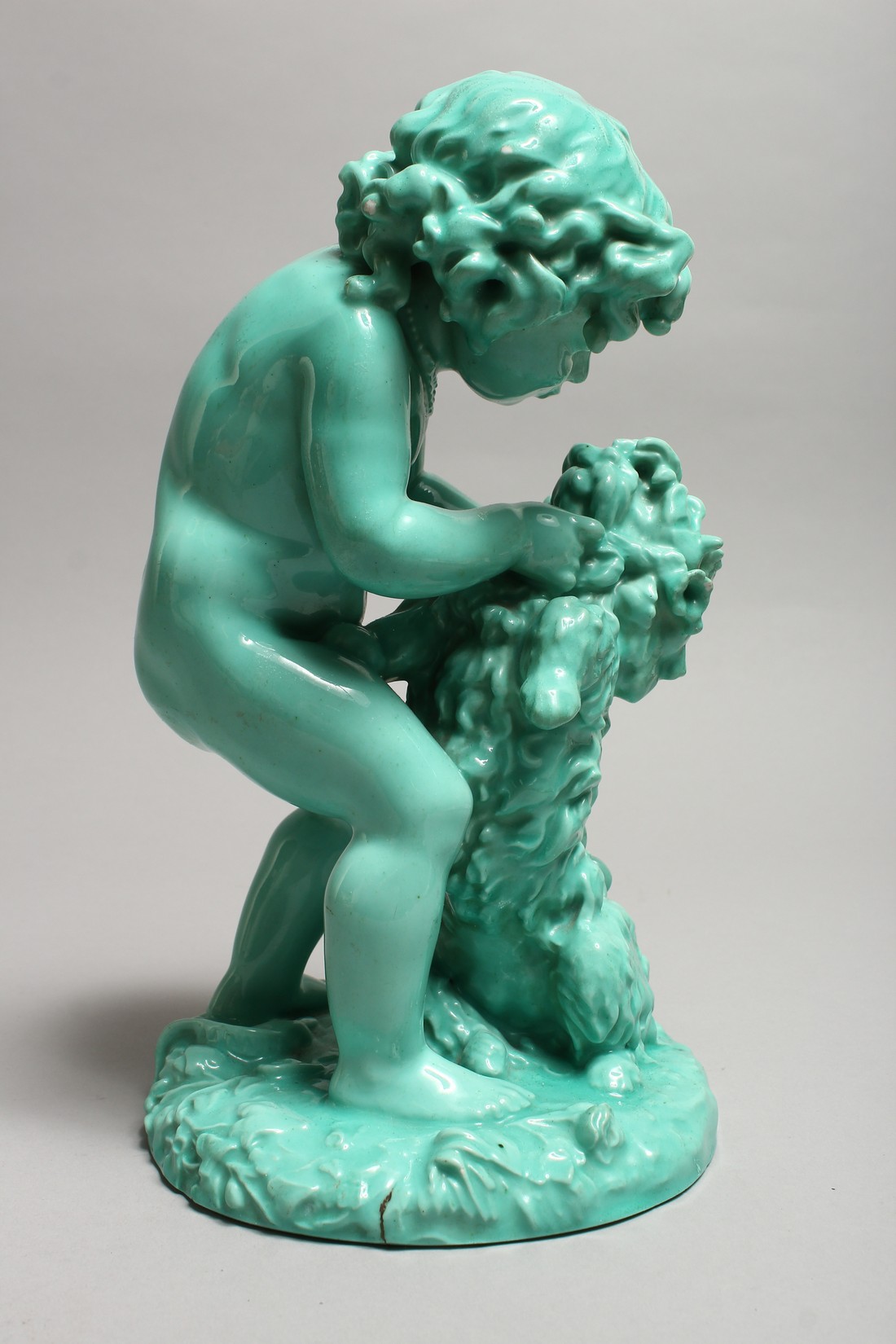 A CONTINENTAL TURQUOISE GLAZED POTTERY FIGURE of a young girl playing with a dog. 11ins high. - Image 3 of 9