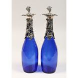 A PAIR OF BRISTOL BLUE DECANTERS with plated fruiting vines.