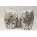 A PAIR OF CHINESE PORCELAIN BARREL SEATS, silver ground, painted with butterflies. 17ins high.