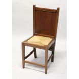 AN UNUSUAL EDWARDIAN MAHOGANY COMBINATION CHAIR/TROUSER PRESS, with panelled back, rush seat on