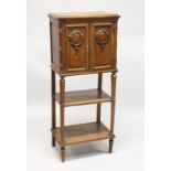 A LATE 19TH CENTURY FRENCH WALNUT MUSIC CABINET, with a pair of carved panelled doors enclosing