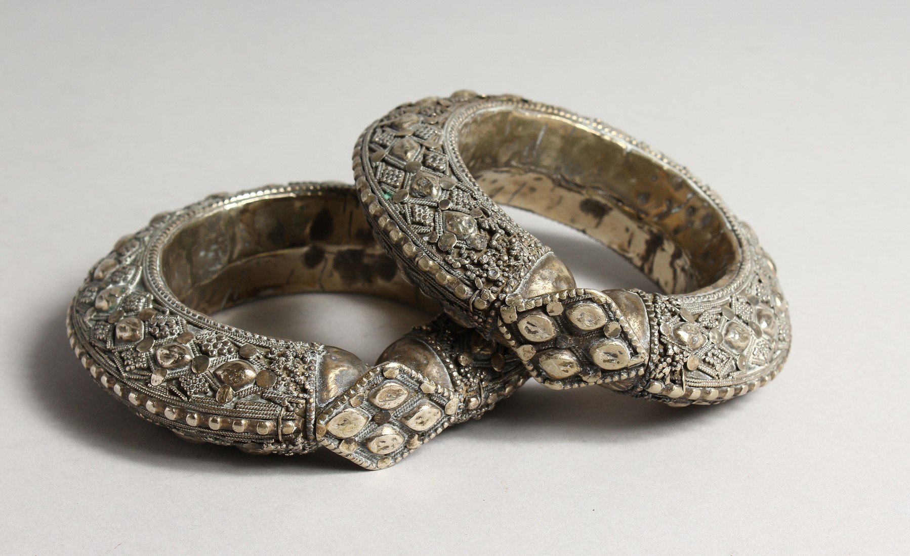 TWO LARGE ISLAMIC SILVER BANGLES