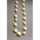 A GOOD GRADUATED IVORY BEAD NECKLACE on thirty beads 18ins long