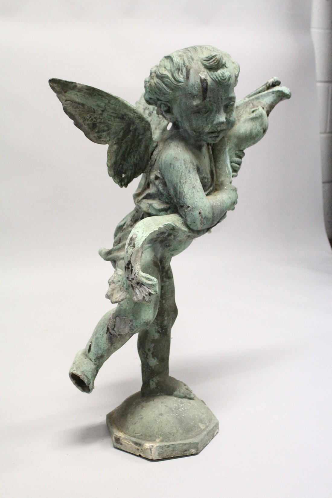 AN 18TH CENTURY LEAD FOUNTAIN as a winged cupid holding a fish, on an octagonal base. 2ft 5ins - Image 2 of 3