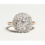 A GOOD 18K GOLD DIAMOND CIRCULAR CLUSTER RING