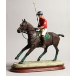 BORDER FINE ARTS. A model of a polo player on a bay horse, model.no. B0875, mounted on a wooden