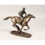 A SMALL, PART COLOURED METAL AND COMPOSITE, MODEL OF A MOUNTED POLO PLAYER ON THE GALLOP. 12ins