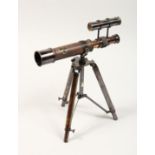 A BRASS TABLE TOP TELESCOPE ON A STAND 10ins high.