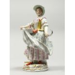 A GOOD MEISSEN PORCELAIN FIGURE OF A GARDENERESE, holding a sickle, carrying a basket of flowers, an