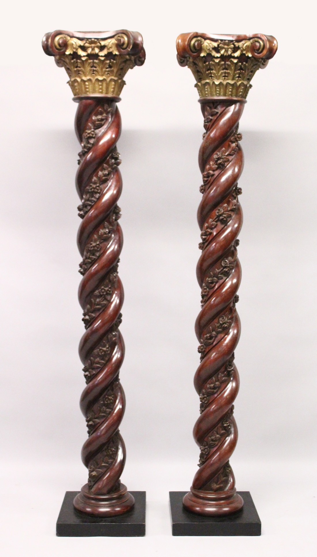 A VERY GOOD PAIR OF 18TH CENTURY CARVED SPIRAL MAHOGANY COLUMNS with carved gilded Corinthian column