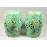 A PAIR OF CHINESE PORCELAIN BARRLEL SEATS, green ground, painted with birds. 17ins high.