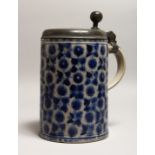 A LARGE GERMAN WESTERWOLD TANKARD, with pewter lid and geometric decoration 9.5ins high