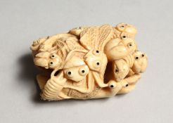 A CARVED BONE NETSUKE