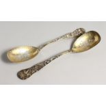 A GOOD PAIR OF VICTORIAN SILVER GILT CAST SPOONS with classical figures. London 1868, maker, Lia's