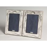 A PAIR OF SILVER PHOTOGRAPH FRAMES IN Art Nouveau style. 7.5ins x 5.5ins.