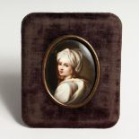 AFTER GUIDO RENE, a porcelain plaque of a young girl 3ins x 2.5ins in a velvet frame.