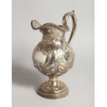 AN R & W WILSON 19TH CENTURY PHILADELPHIA SILVER JUG repousse with flowers and scrolls 8ins high,