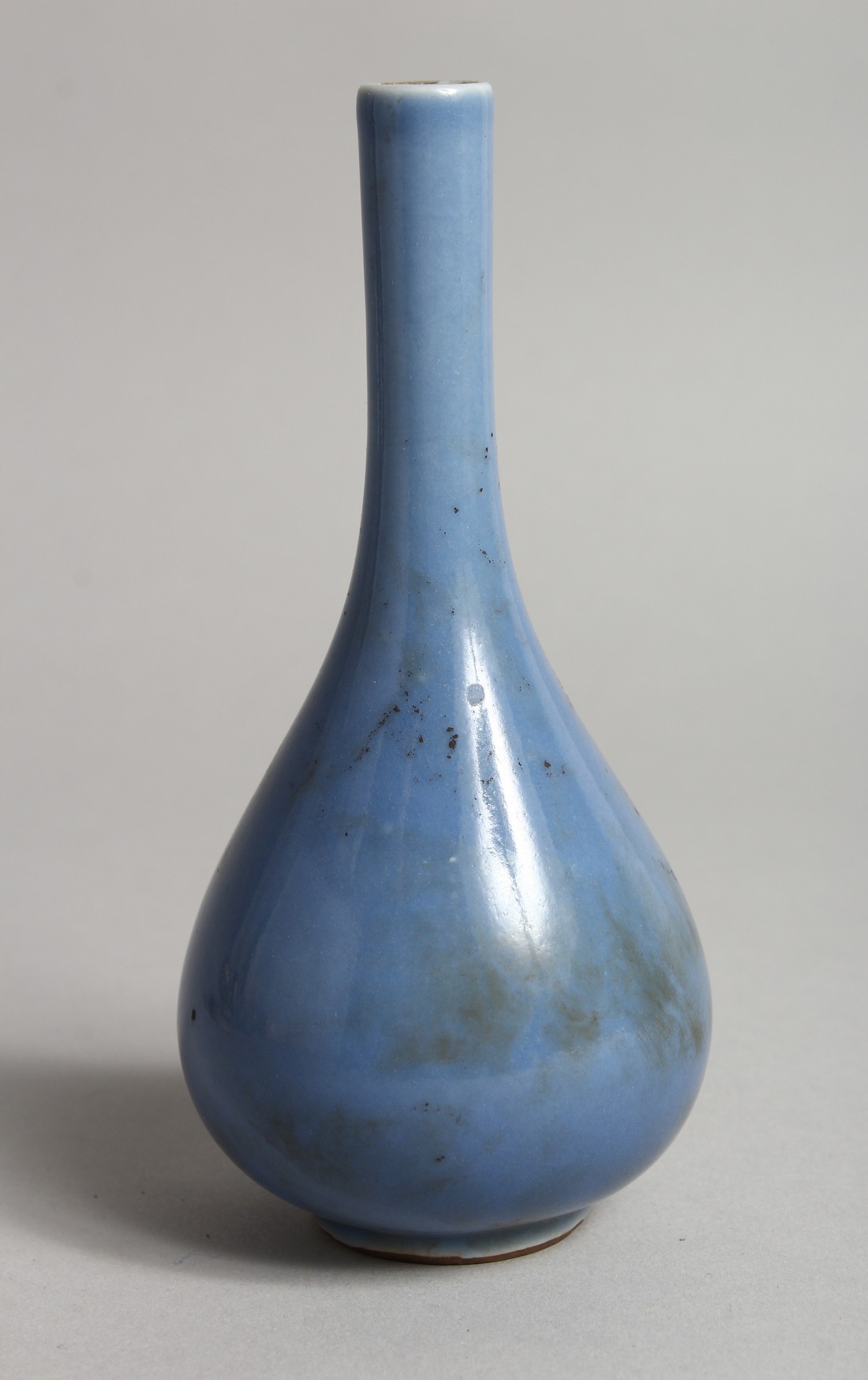 A SMALL CHINESE BLUE GROUND VASE with tall neck 5.5ins high.