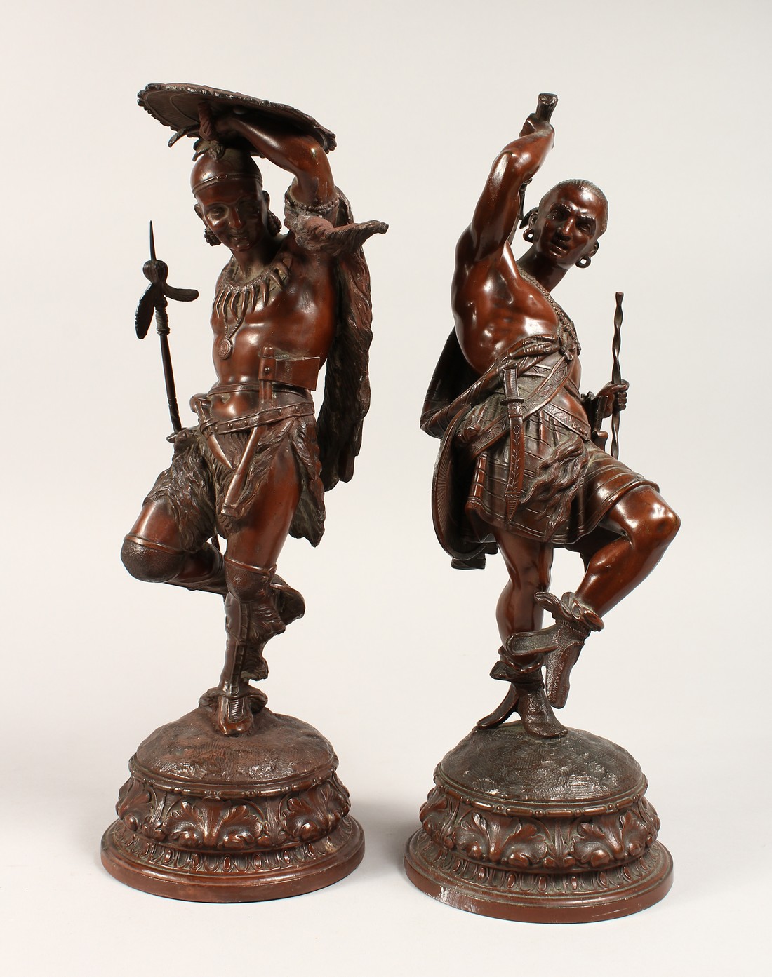 A SUPERB PAIR OF BRONZED-METAL NATIVE AMERICAN FIGURES, on circular bases with wall brackets (4)