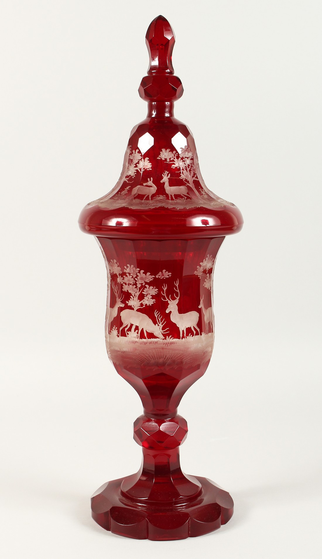 A SUPERB LARGE VICTORIAN BOHEMIAN RUBY GOBLET AND COVER etched with deer in a landscape. 20ins