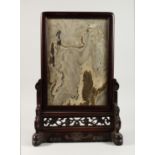 A CHINESE TABLE SCREEN, the pierced and carved wood frame inset with a hardstone plaque. 23ins