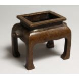 A CHINESE BRONZE RECTANGULAR CENSOR, on four curving legs 5.5ins long