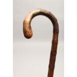 A RUSTIC WALKING STICK 2ft 8ins long