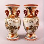 A PAIR OF JAPANESE MEIJI PERIOD KUTANI PORCELAIN VASES - each with twin handles and a flared rim,